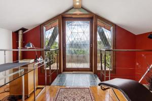 a room with red walls and a large window at Quinta das Cavadas in Canedo +26 photos