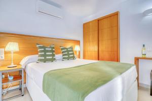 a bedroom with a large bed with a wooden headboard at Villa Ginevra in Arona +37 photos