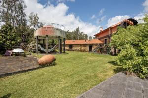 a large yard with a gazebo and a house at Quinta das Cavadas in Canedo