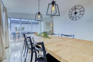 a dining room with a large wooden table and chairs at Villa Ginevra in Arona