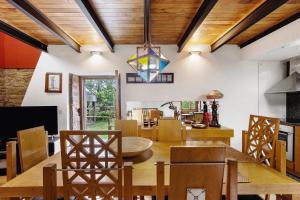 a dining room with a wooden table and chairs at Quinta das Cavadas in Canedo