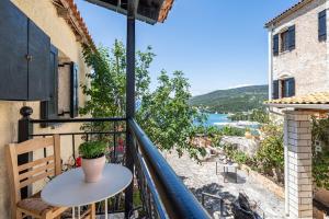 a balcony with a table and a view of the ocean at Old manor house in Syvota