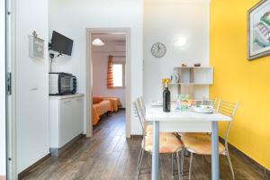 a kitchen and dining room with a table and chairs at Holiday vista Montagna in Cala Gonone