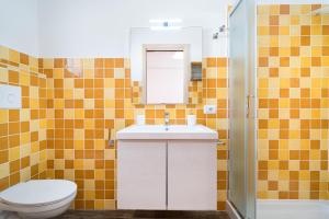 a bathroom with a sink and a toilet at Holiday vista Montagna in Cala Gonone +12 photos
