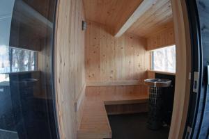 a sauna in a wooden cabin with a window at HARUNA WING Relax in a private cottage in the forest,enjoying the breathtaking view from a cypress wood sauna in Tsumagoi +43 photos