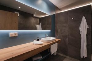 a bathroom with a sink and a mirror at Valentinerhof Apt Aqua in San Michele +28 photos