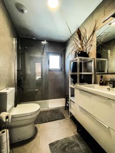 a bathroom with a toilet and a tub and a sink at Atico Bremadito in Torrox Costa