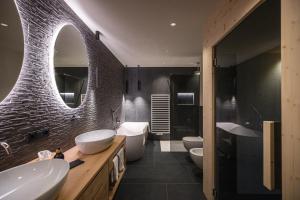 a bathroom with two sinks and two toilets at Rueper Hof Chalet Pracken in Valdaora +18 photos