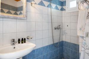 a bathroom with a sink and a shower at Maria in the castle Kea in Ioulis +23 photos