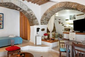 a living room with a couch and a table at Maria in the castle Kea in Ioulis