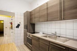 a kitchen with wooden cabinets and a sink at Luckau Appartements 1695 in Luckau +79 photos