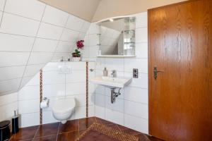 a bathroom with a toilet and a sink at Ferienwohnung Vierheller in Lauterbach +15 photos