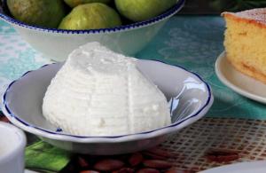a bowl of white frosting on a table with a cake at Bed and Breakfast Torrette Etrusche in Capalbio +43 photos