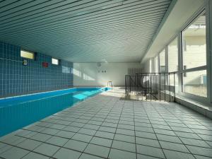 an empty swimming pool in a building at Black Forest Home in Schönwald