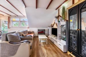 a living room with two couches and a tv at Apartment Malsam in Bräunlingen