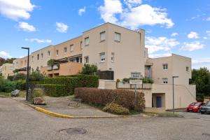 an apartment building with a fire hydrant in front of it at Terrasse de Malissol in Vienne