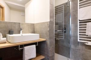 a bathroom with a sink and a shower at Furnerhof Apt Stearnzauber in Collepietra +27 photos
