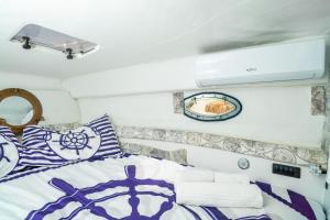 a bedroom with a bed with blue and white pillows at Etna's boat house in Piedimonte Etneo
