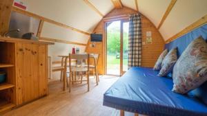a bedroom with a bed and a table in a room at Woodclose Park in Kirkby Lonsdale