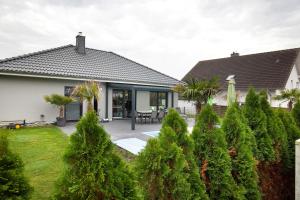 a house with a patio and trees in the yard at Ferien Marx in Oberbrechen