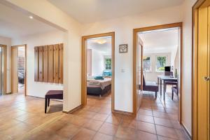 a room with a bedroom and a bed and a table at Haus Wacholder in Undeloh