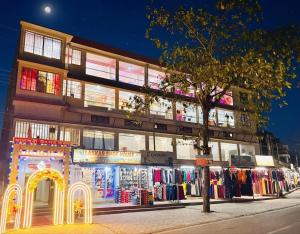 a building with a lot of clothes in front of it at Mannat Lodge in Hailākāndi