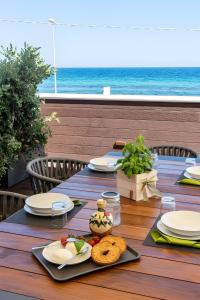 a table with plates of food sitting on top of a table at Luxury terrazza in Bari