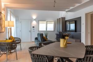 a living room with a table and chairs at Luxury terrazza in Bari