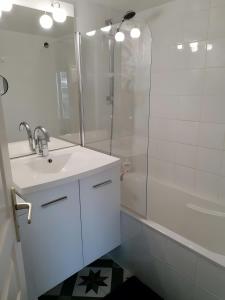 a white bathroom with a sink and a shower at Maison La Vendéenne - Ref 508 in La Tranche-sur-Mer