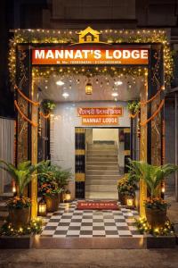a entrance to a manetts lodge with lights and plants at Mannat Lodge in Hailākāndi +4 photos