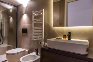 a bathroom with a white sink and a toilet at Luxury terrazza in Bari +28 photos