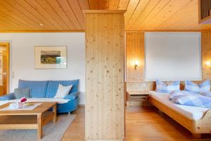 a room with a bed and a couch and a table at Appartment Bergblick in Bernau im Schwarzwald