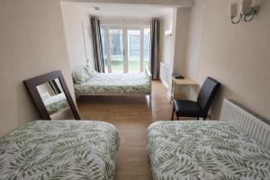 a living room with two chairs and a couch and a table at ValueStays Chalvey Free Parking in Slough