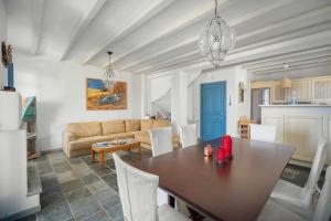 a living room with a table and a couch at Almira in Livadi