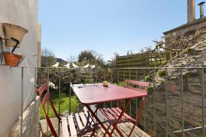 a red table and chairs in a garden at Quartier De La Madeleine in Angers