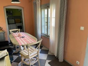 a kitchen with a table and chairs and a window at Ferienhaus Sommerhaus Julin in Saal +24 photos