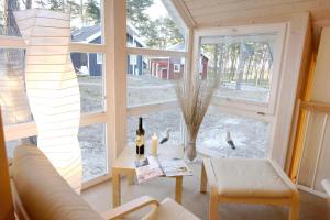 a living room with a large window and a couch at Ferienhaus 254 Strandpark Baabe in Baabe