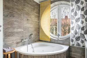 a bath tub in a bathroom with a window at Sonnenuferhaus in Kosel +19 photos