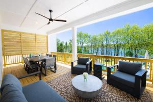 a screened in porch with a view of the water at Paddle Pointe in Sherrills Ford