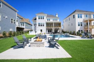 a yard with benches and a fire pit in front of a house at Paddle Pointe in Sherrills Ford