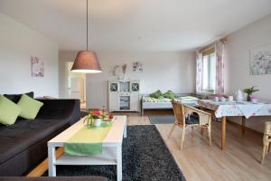 a living room with a couch and a table at Ferienwohnung Postel in Meldorf +12 photos