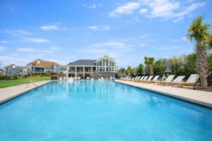 a large swimming pool with chairs and a house at Paddle Pointe in Sherrills Ford
