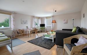 a living room with a couch and a table at Ferienwohnung Postel in Meldorf