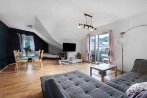a living room with a couch and a table at Haus Castellbergblick Dachgeschoss in Ballrechten