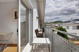 a balcony with a table and a view of the city at Haus Castellbergblick Dachgeschoss in Ballrechten
