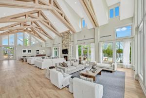 a living room with white furniture and large windows at Paddle Pointe in Sherrills Ford