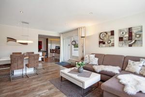 a living room with a couch and a table at Ferienwohnung Am Wald in Eslohe