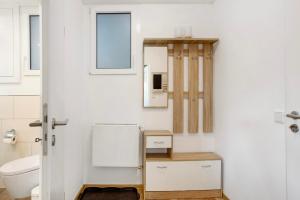 a bathroom with a toilet and a mirror at Ferienwohnung Am Wald in Eslohe +19 photos