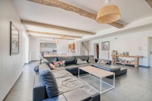 a living room with a couch and a table at Villa Virginie gite 1 in Faudoas
