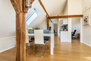a kitchen and dining room with a white table and chairs at Pendler- und Ferienwohnung Bröke in Ahaus +12 photos